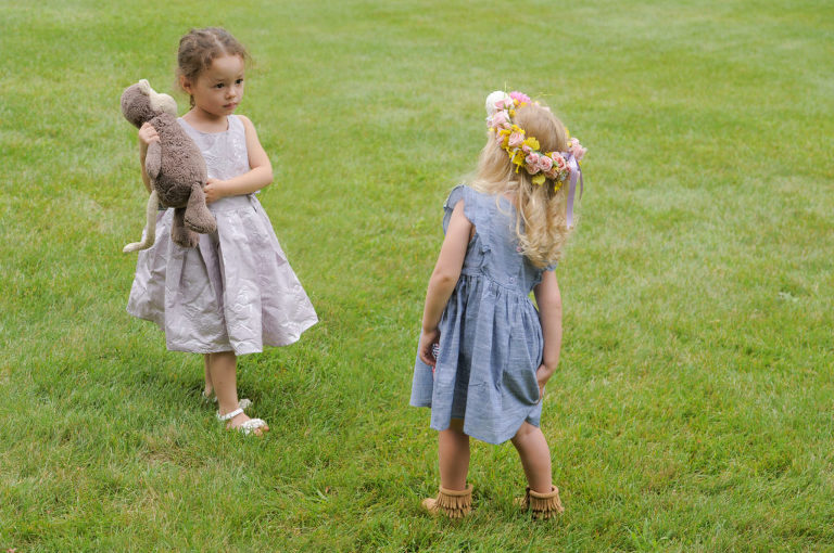 Two little girls size each other up before the Indian Springs Metropark wedding in White Lake, Michigan.