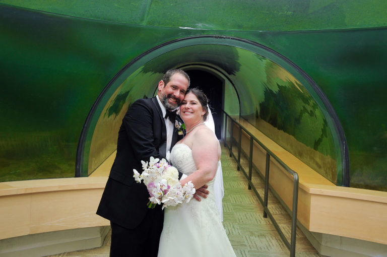 The bride and groom hang out in the Environmental Discovery Center after the wedding ceremony at the Indian Springs Metropark wedding in White Lake, Michigan.