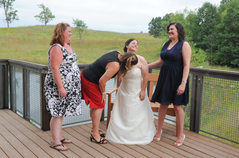The bride gets motor boated by a friend after her wedding at the Indian Springs Metropark in White Lake, Michigan.