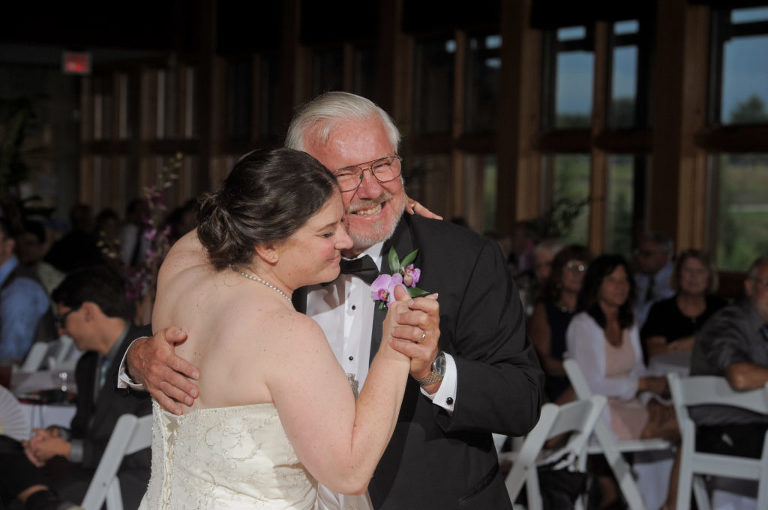 The bride and her father share a first dance at the Environmental Discover Center at the Indian Springs Metropark in White Lake, Michigan.