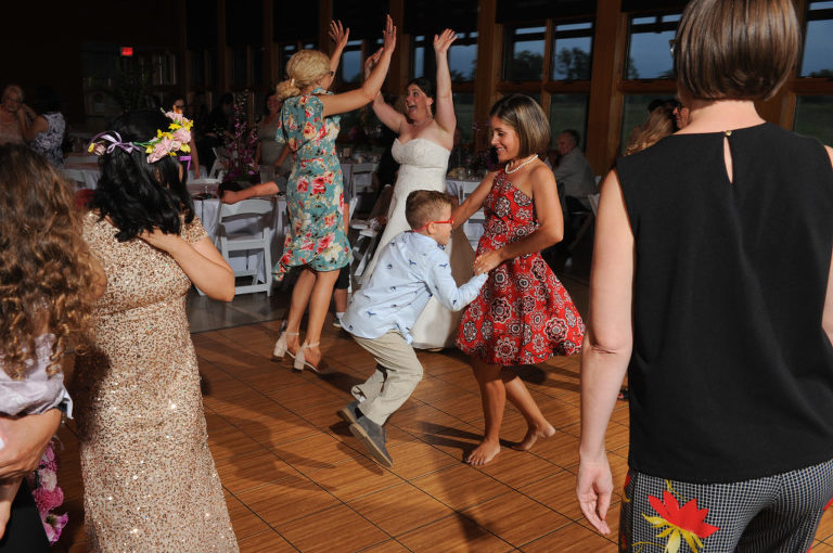 The brides dances with her friends and family at the Environmental Discover Center at the Indian Springs Metropark in White Lake, Michigan.