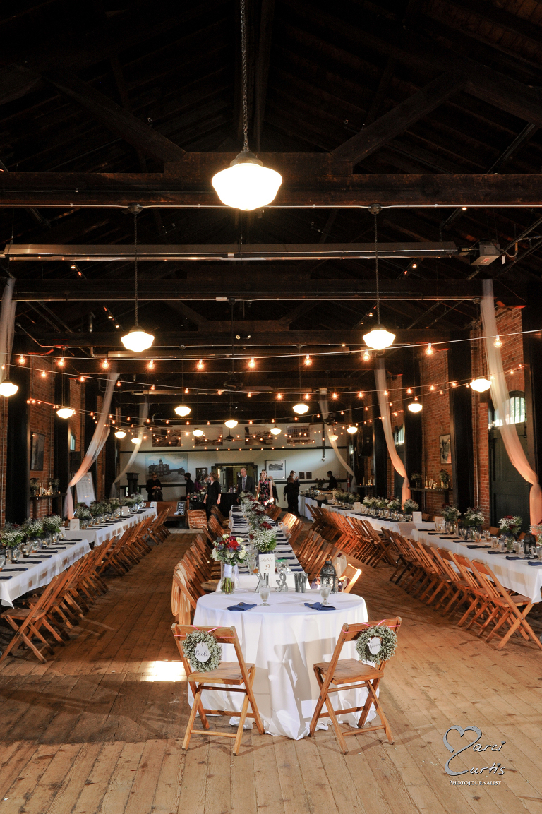 Interior of the Freighthouse with rows of tables. Ypsilanti Freighthouse wedding photography of the newly renovated historic building in Depot Town, Ypsilanti, Michigan.