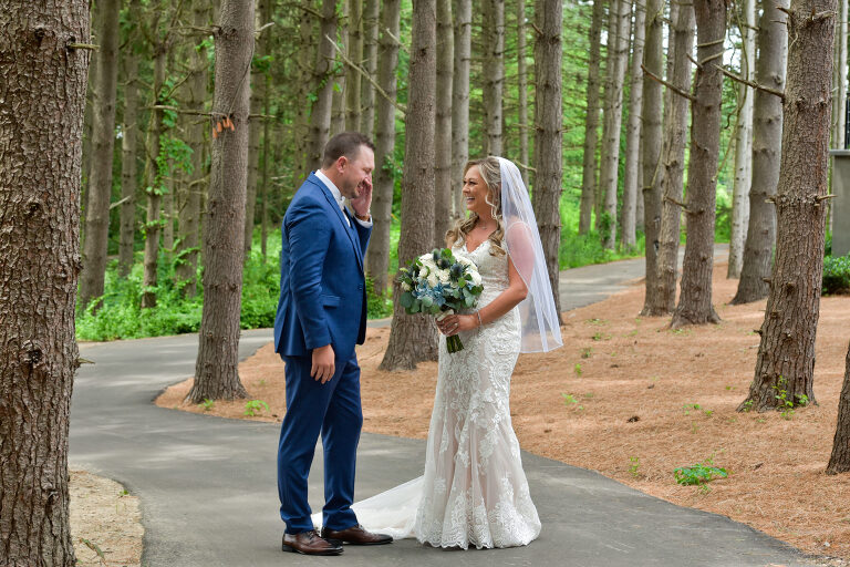 The groom tears up after the first look with the bride at Shepherd's Hollow's new wedding venue in Clarkston, Michigan.