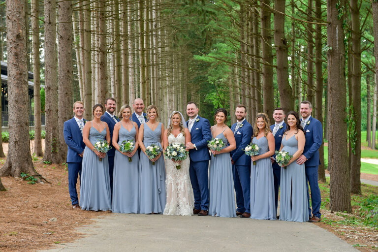 Using the dramatic lodge pole pines as a backdrop for wedding photos was a no brainer at Shepherd's Hollow's new wedding venue in Clarkston, Michigan, which even worked with this fairly large wedding party.