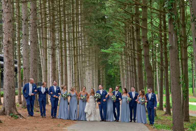 Using the dramatic lodge pole pines as a backdrop for wedding photos was a no brainer at Shepherd's Hollow's new wedding venue in Clarkston, Michigan, which even worked with this fairly large wedding party.