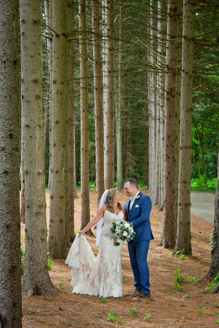 Using the dramatic lodge pole pines as a backdrop for photos of the bride and groom at Shepherd's Hollow's new wedding venue in Clarkston, Michigan. It was incredibly hard to choose a favorite from these photos.