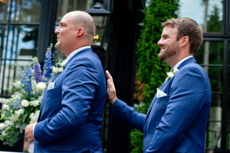 A groomsman places his hand reassuringly on the back of the best man after he struggled to find the rings during the ceremony at Shepherd's Hollows Golf Club Clarkston, Michigan.