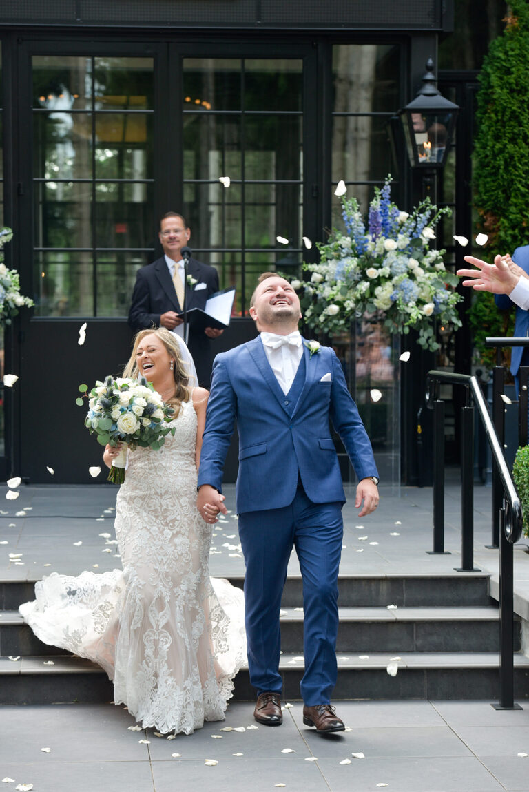 At the end of the ceremony at Shepherd's Hollows Golf Club Clarkston, Michigan, their playful parents let loose with rose petals thrown at the bride and groom.