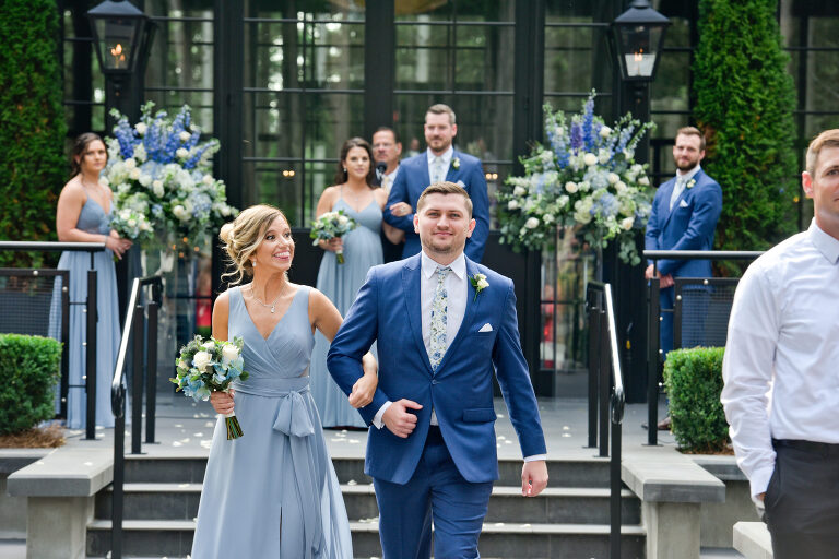 A funny moment captured from a bridesmaid during her exit after the wedding ceremony at Shepherd's Hollows Golf Club Clarkston, Michigan.