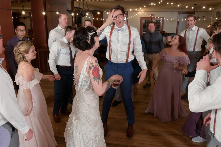 The bride and groom share a moment of levity at Greenfield Village in Dearborn, Michigan.