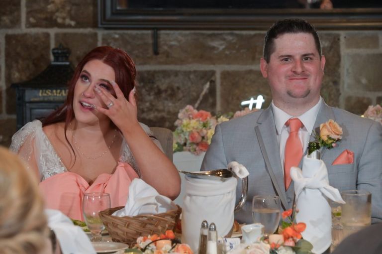 The bride catches her tears during an emotional toast at her wedding at Wellers in Saline, Michigan.