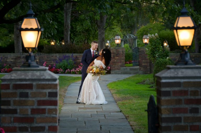 Playing in the Meadowbrook gardens after their wedding in Rochester, Michigan.