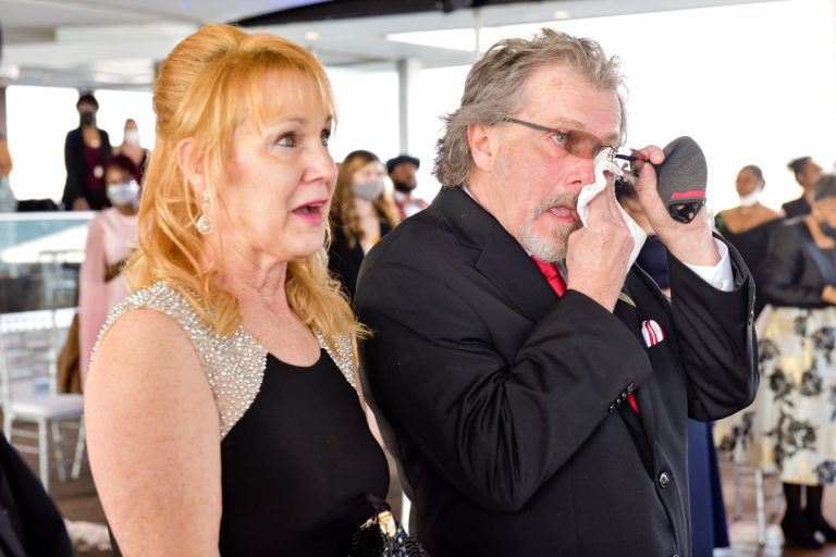 Guests wipe their eyes during an emotional wedding ceremony at Detroit's Roostertail.