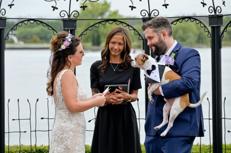 The couple's dog joins the ceremony at the pergola at Roostertail.