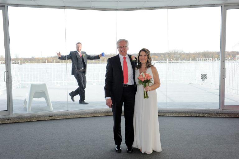 The bride and groom get photo bombed at the top wedding venue, Roostertail in Metro Detroit, Michigan.