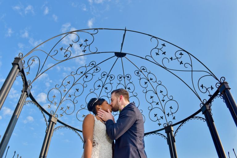 Bride and groom portrait under the pergola at the top wedding venue, Roostertail in Metro Detroit, Michigan.