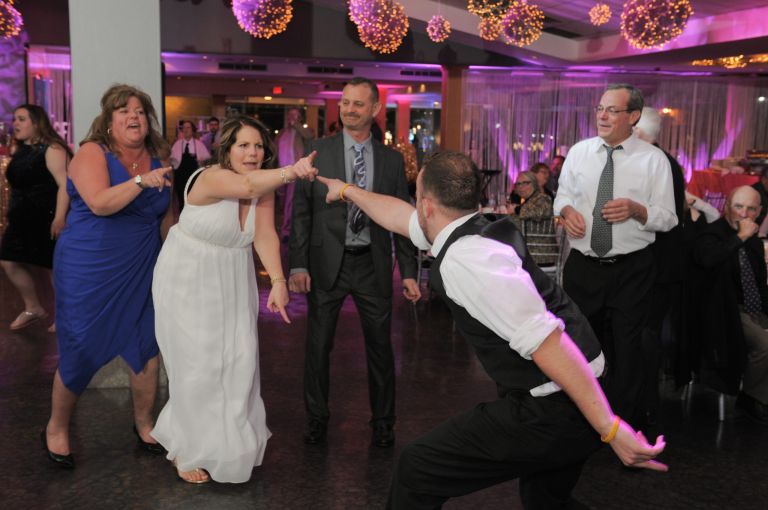 The bride has a danceoff with her new stepson atRoostertail in Detroit, Michigan.