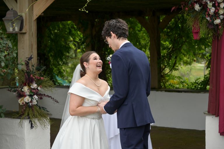 The bride and groom's first look at a fall wedding at Addison Oaks Buhl Estates in Leonard, Michigan.