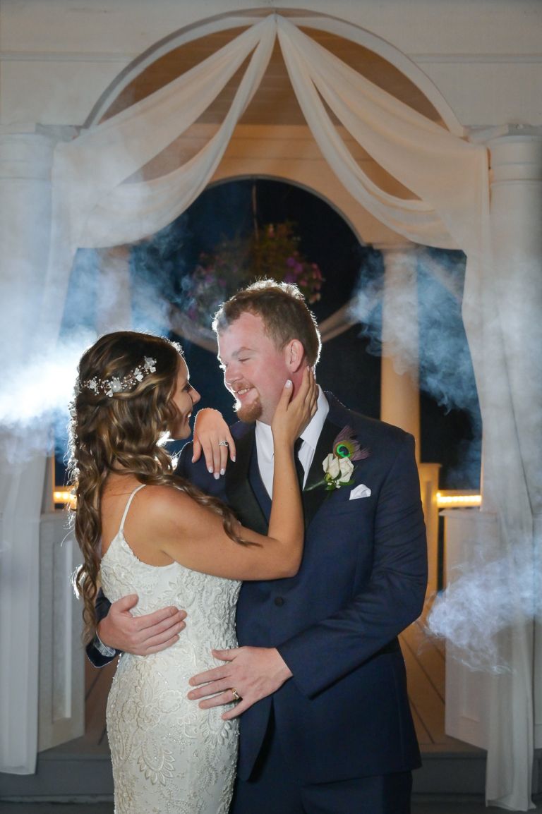 Couple surrounded by smoke after their wedding.