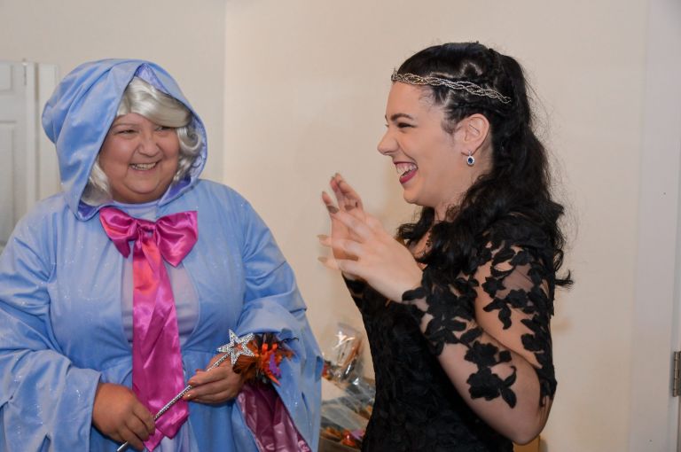 The bride chats with the fairy godmother at the Canterbury Village for the Halloween themed wedding.