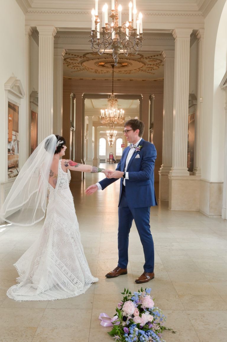 The bride and groom having some fun posing in the hallways at the Henry Ford Museum in Dearborn, Michigan.