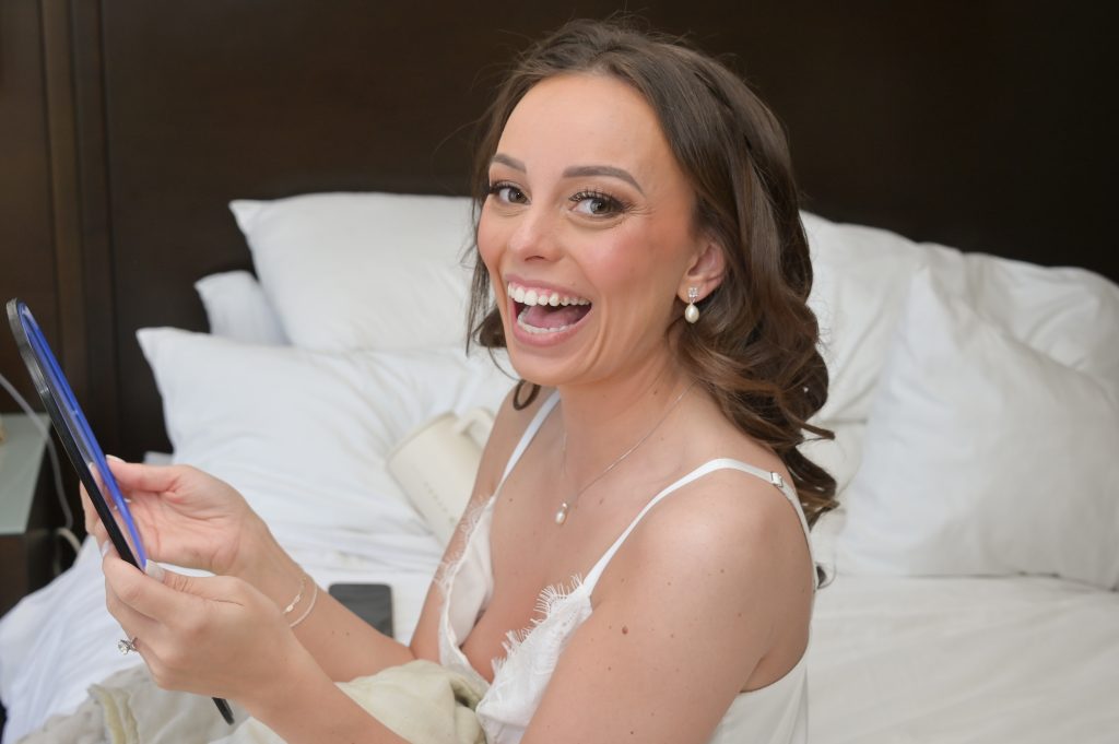 Bride sees herself in makeup for first time.