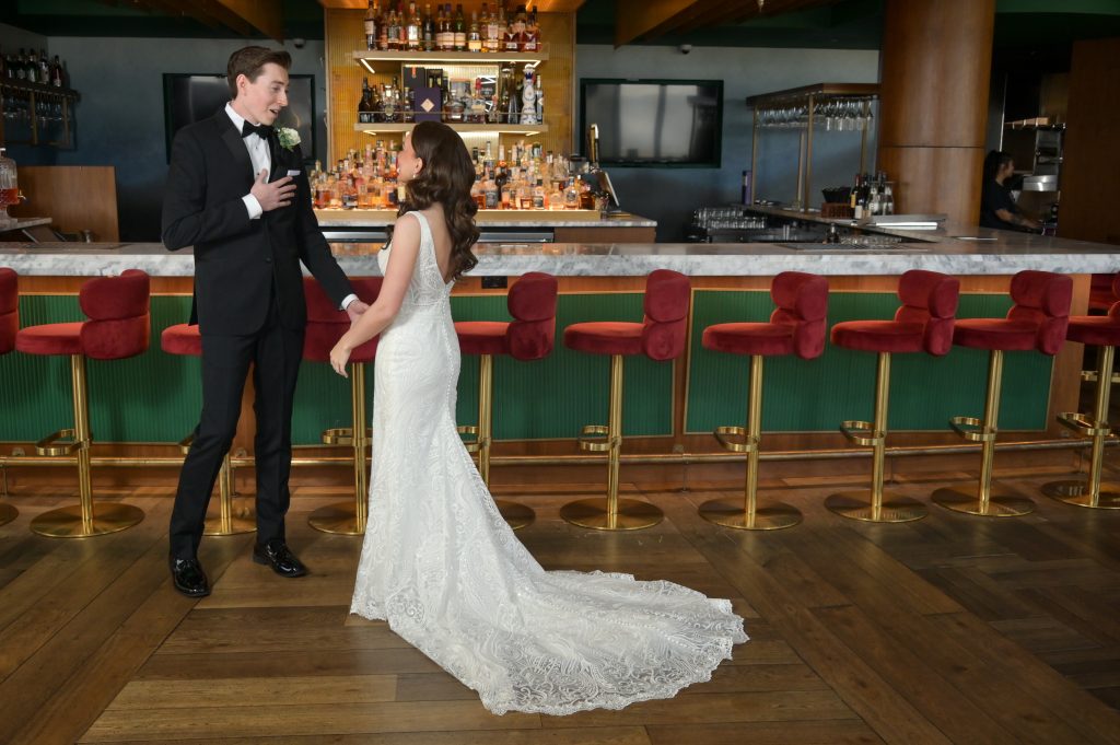 First Look with his hand on his heart as he sees his bride for the first time at the Highlands bar.