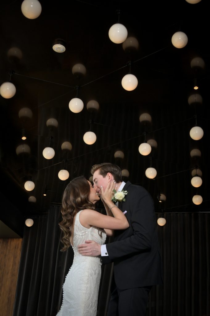 The bride and groom smooching and dancing at the bar at the Highlands Detroit.
