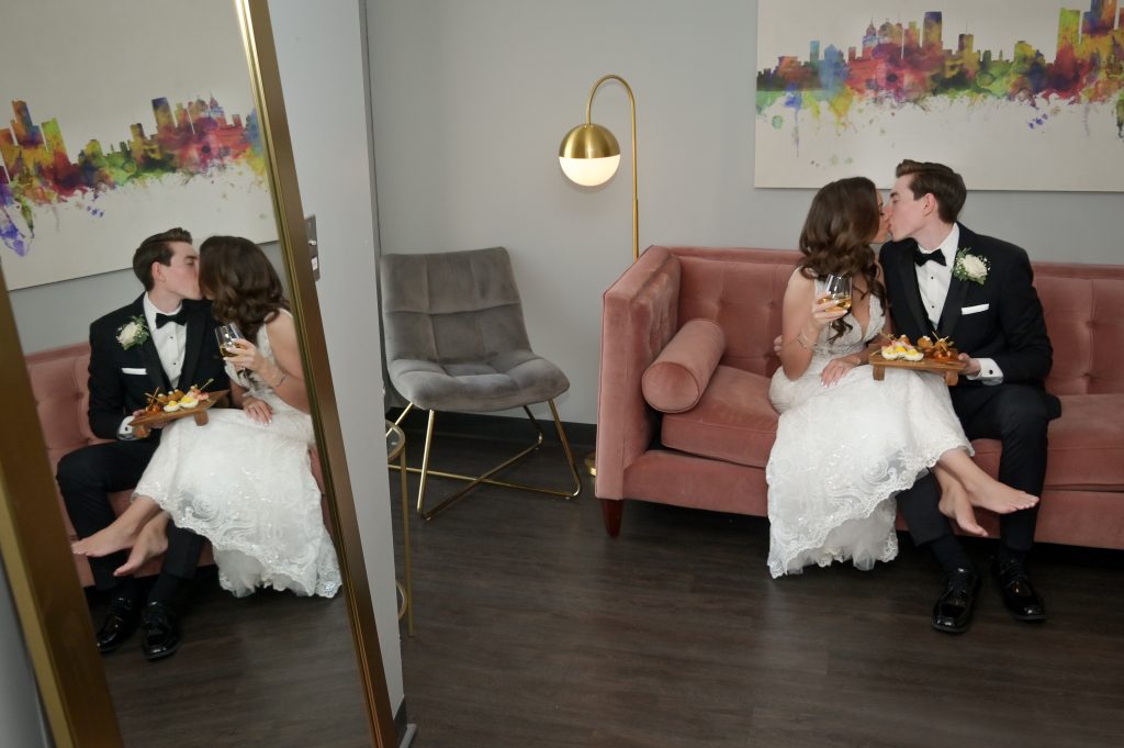 The bride and groom get snacks in the bridal suite before joining their cocktail hour at Highlands Detroit.