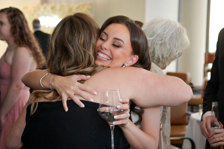The bride hugs her guests at her wedding at the Highlands during cocktail hour.