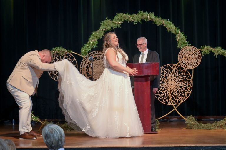 The groom checks under the bride's dress during their wedding ceremony at Pontiac's Crofoot.