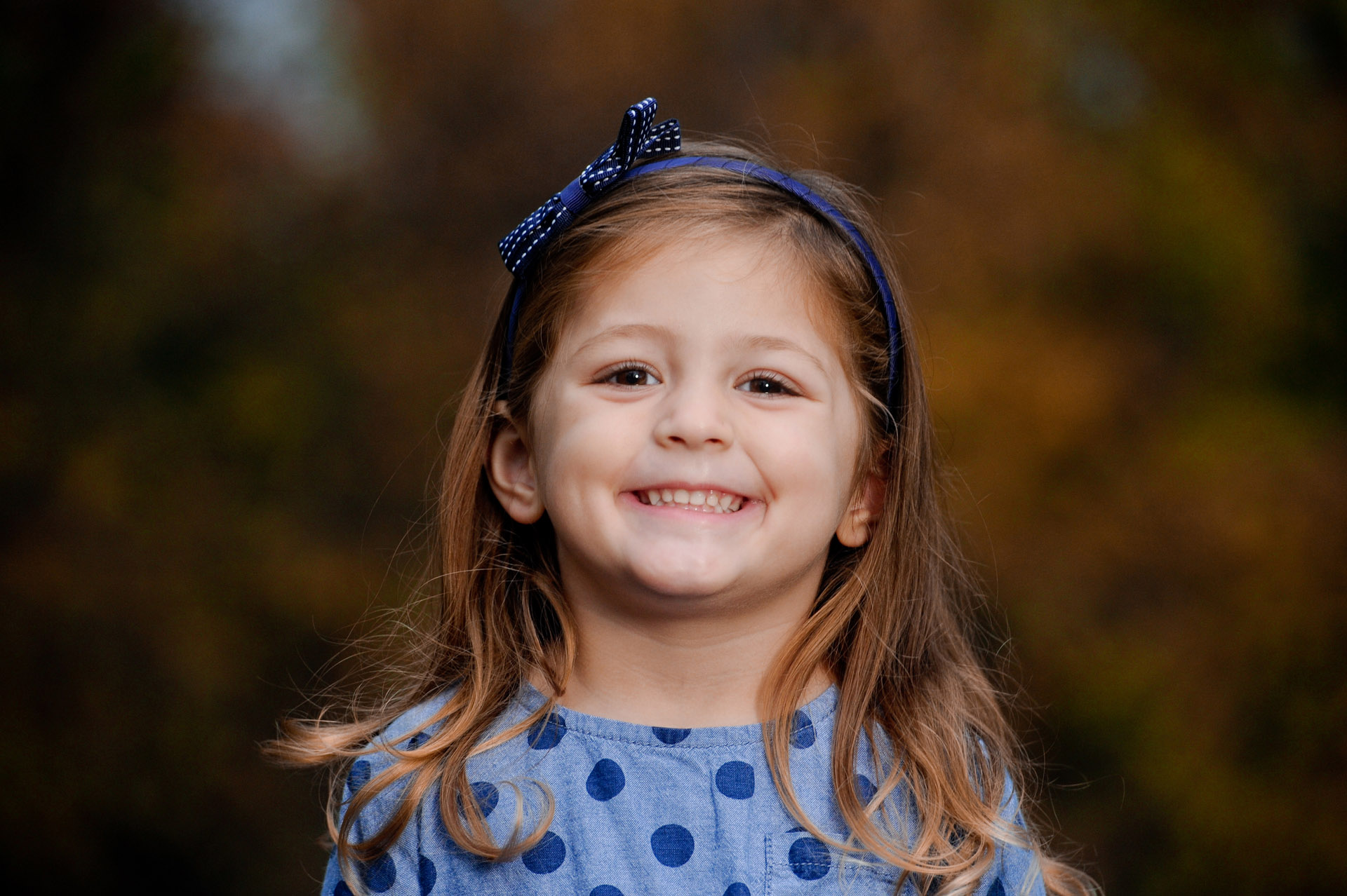 Capturing candid expressions and smiles, like this little girl's is what this best Detroit kids photographer does best as a Detroit, Michigan kid's portrait photographer.