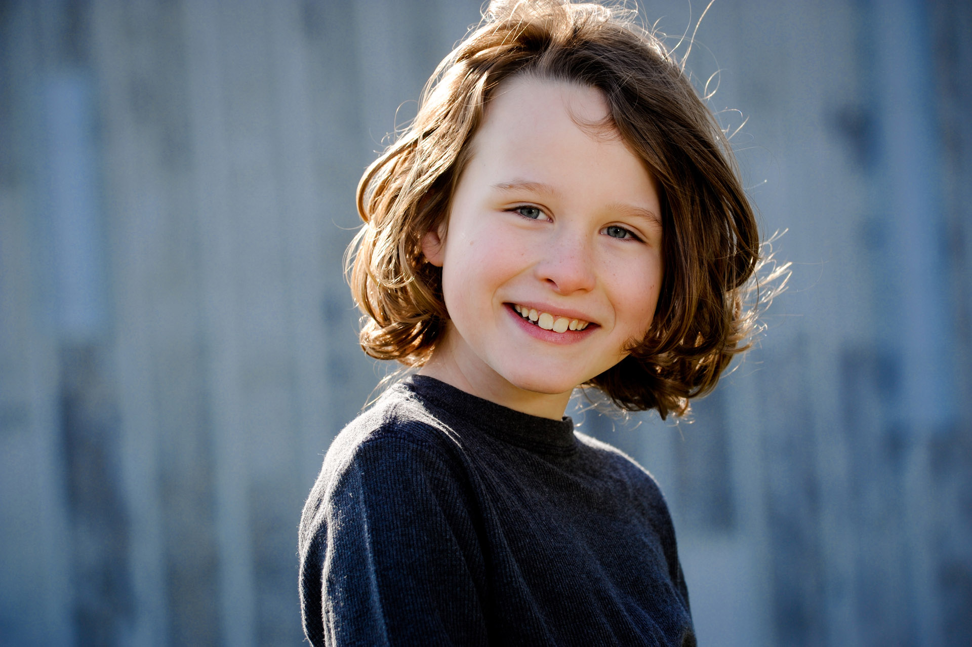Best Detroit children photographer's fun and candid kid's portrait of of of the boys just sitting in perfect light during a photography session in Troy, Michigan.