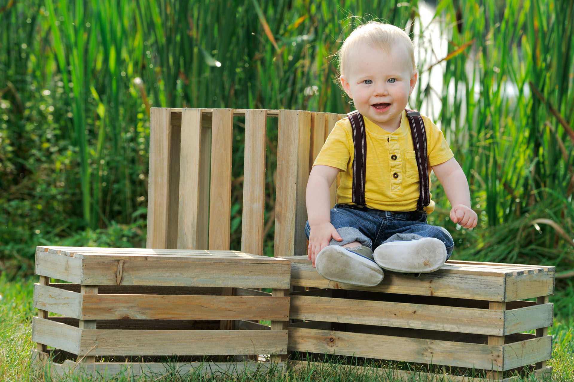 Best Detroit children photographer's portrait of this little boy sitting on a crate during his children's session in metro, Michigan.