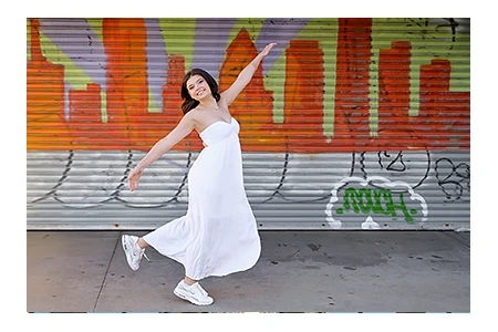 A high school senior jumps through a Detroit scene for her senior photos in Detroit, MI