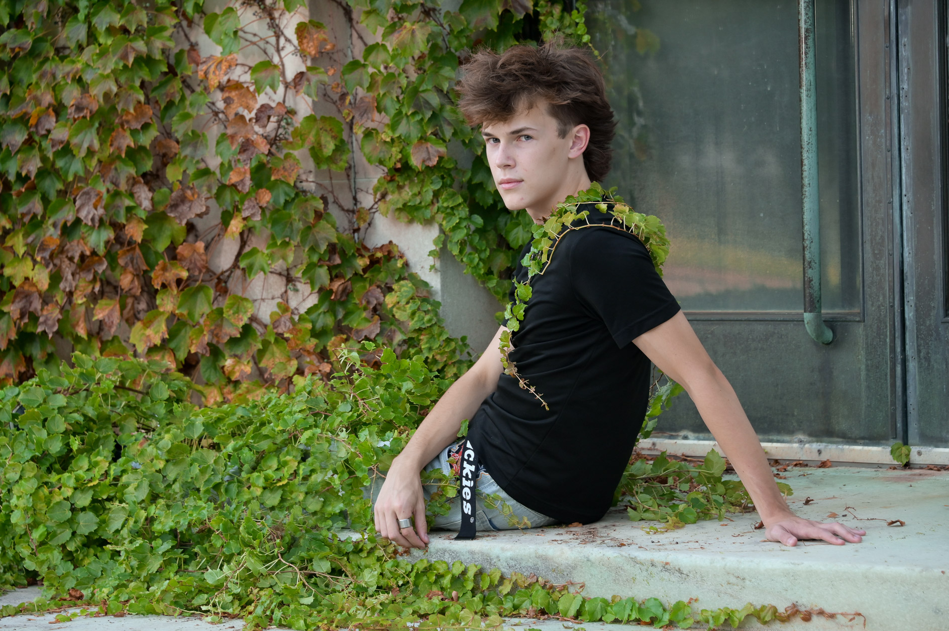 Settling into the vines on the steps of an abandoned building created this classic, unique senior photo.