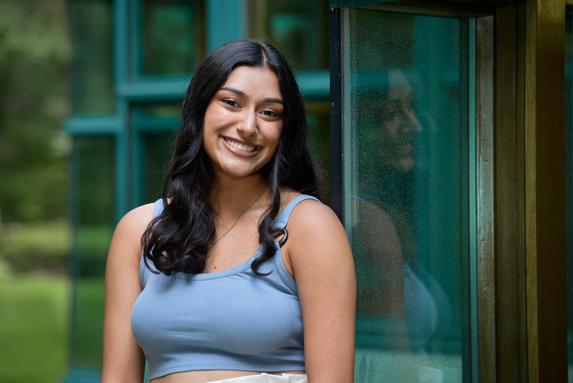 Rochester senior reflecting in a window in Rochester, Michigan.