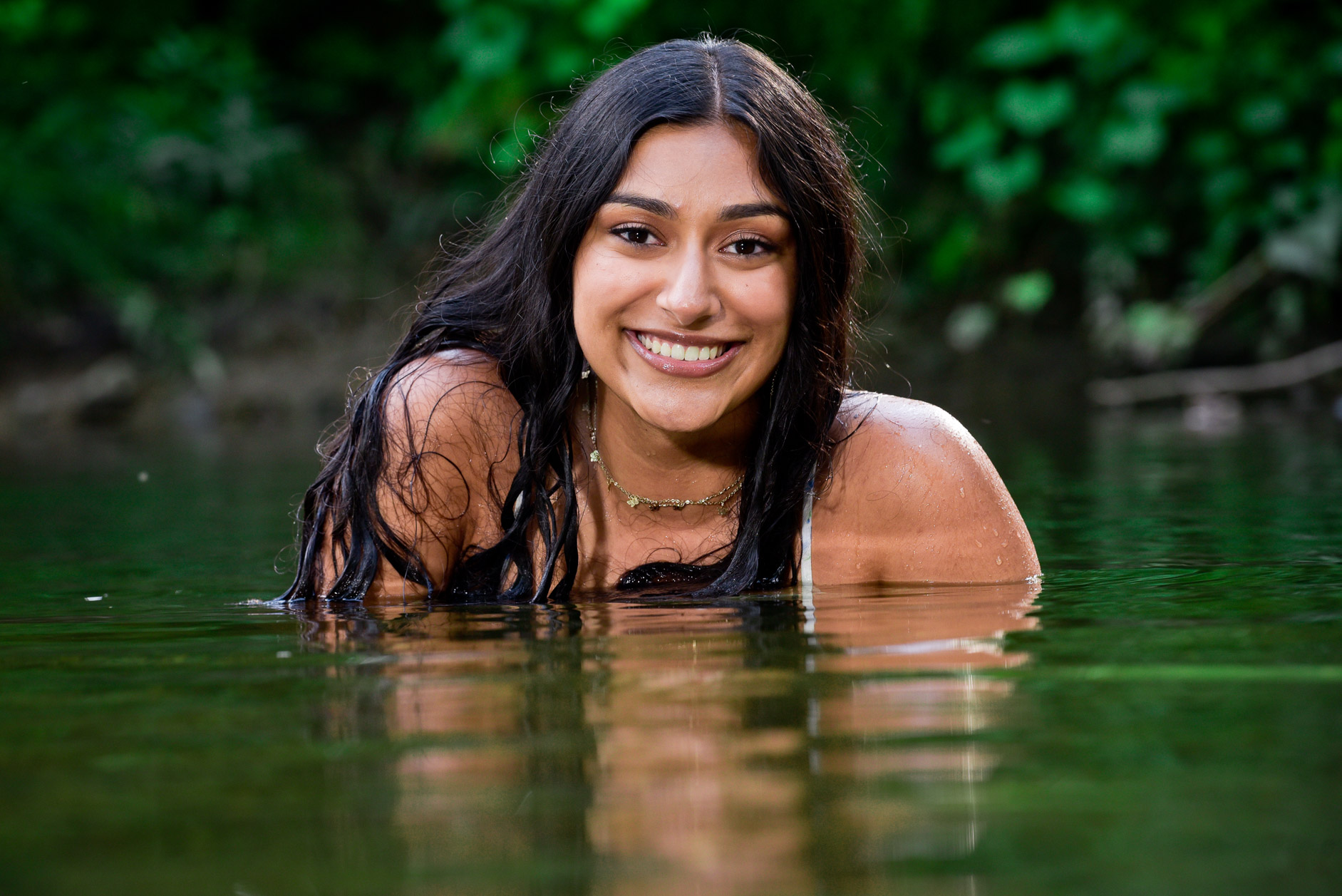 Rochester High swimmer senior submerges herself in water near Rochester, Michigan for these cool swimmer senior photography. 