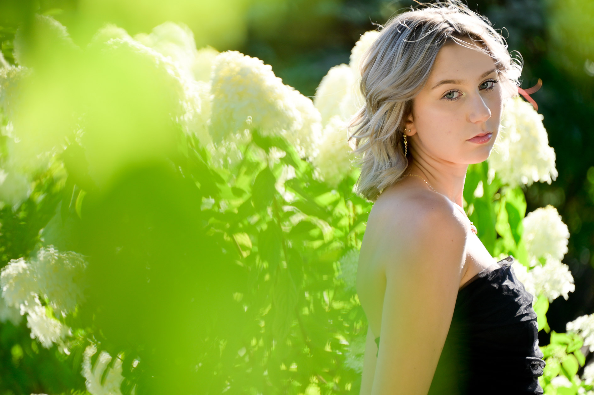Troy High school senior Victoria looking serious for her series of garden floral photos taken near Troy, Mich.