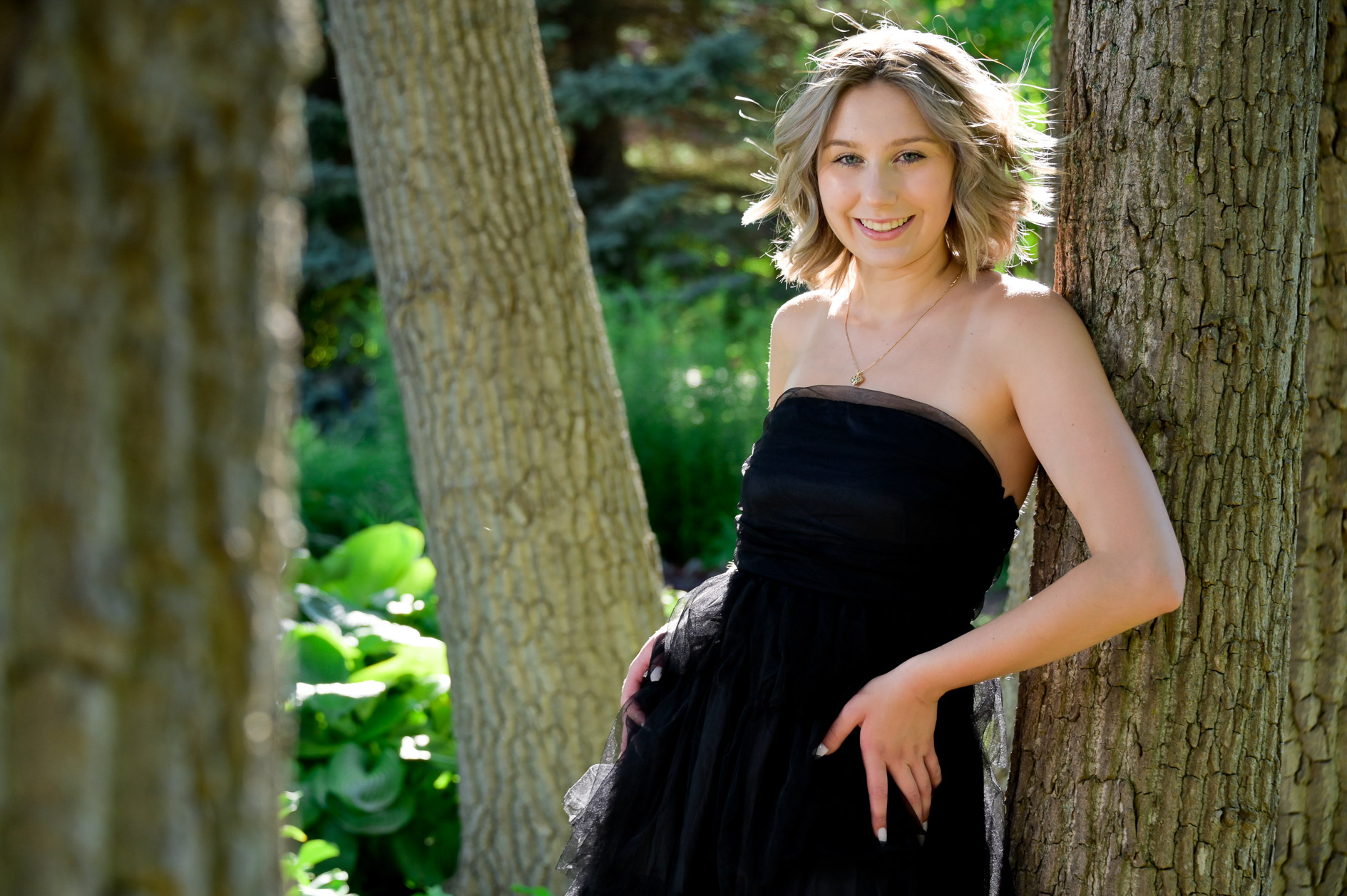 Cute Troy senior photo taken in trees.