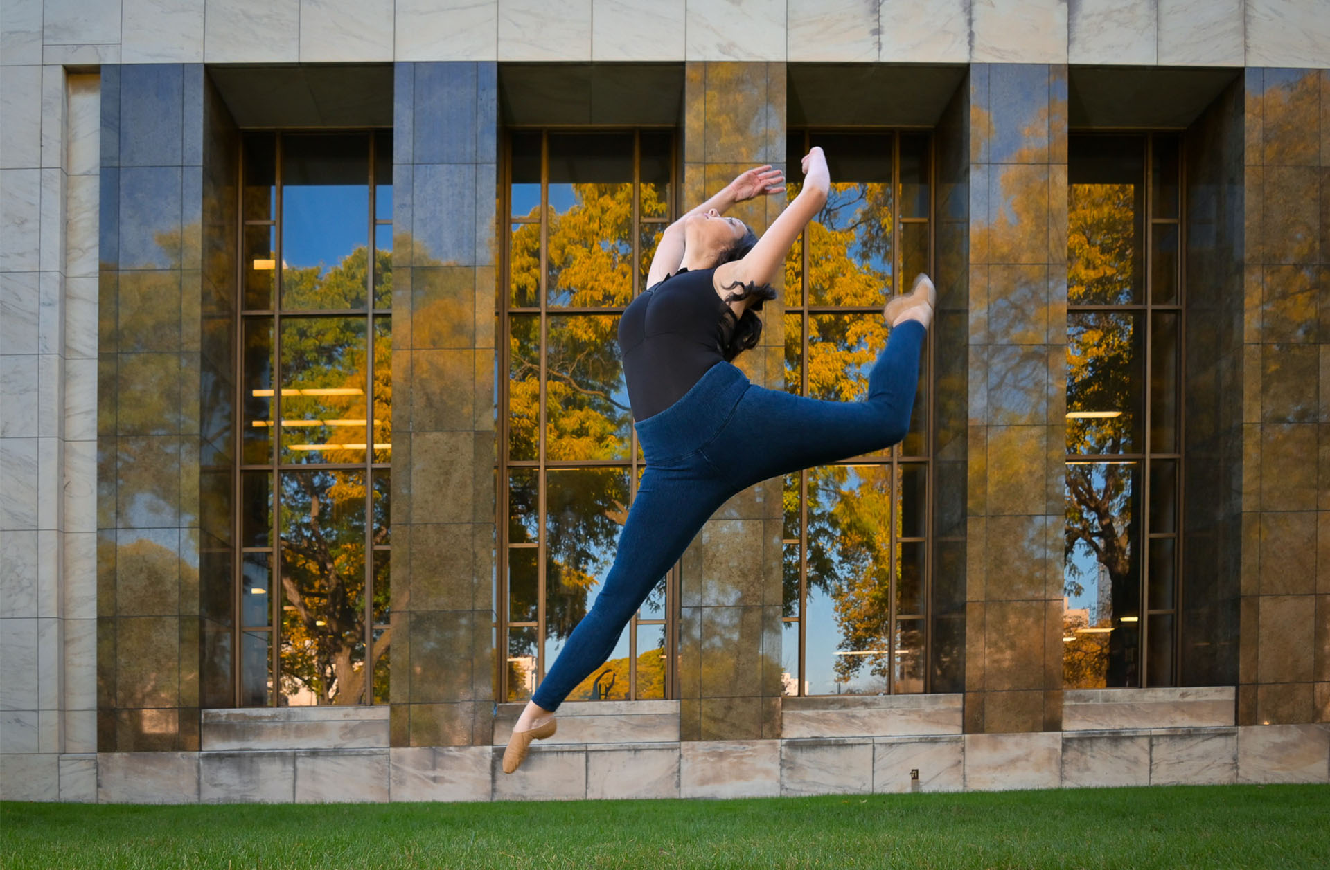 Classic Detroit architecture in the background of this Troy, MI senior's leap showing fall colors.